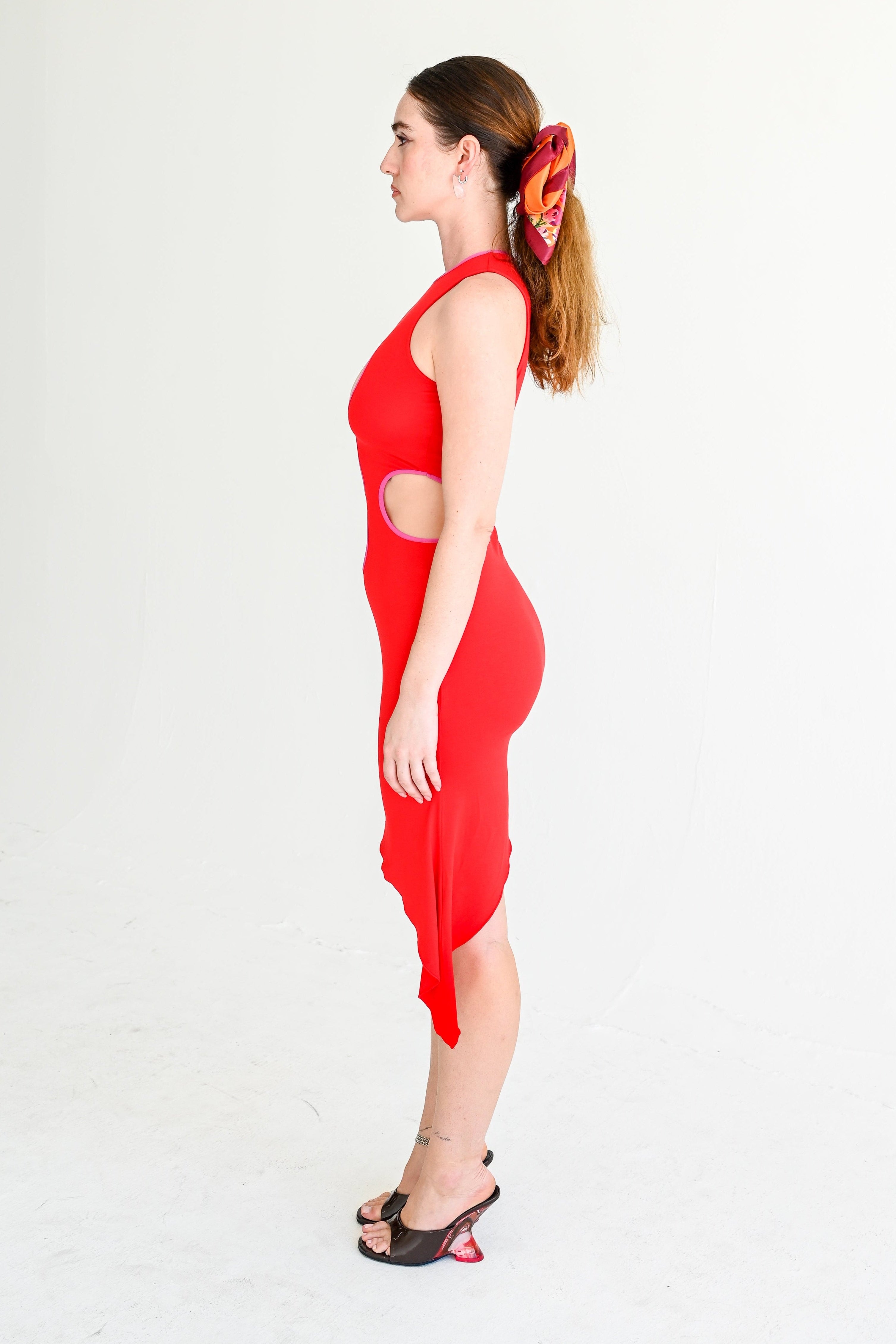 Woman wearing a red dress with a white background