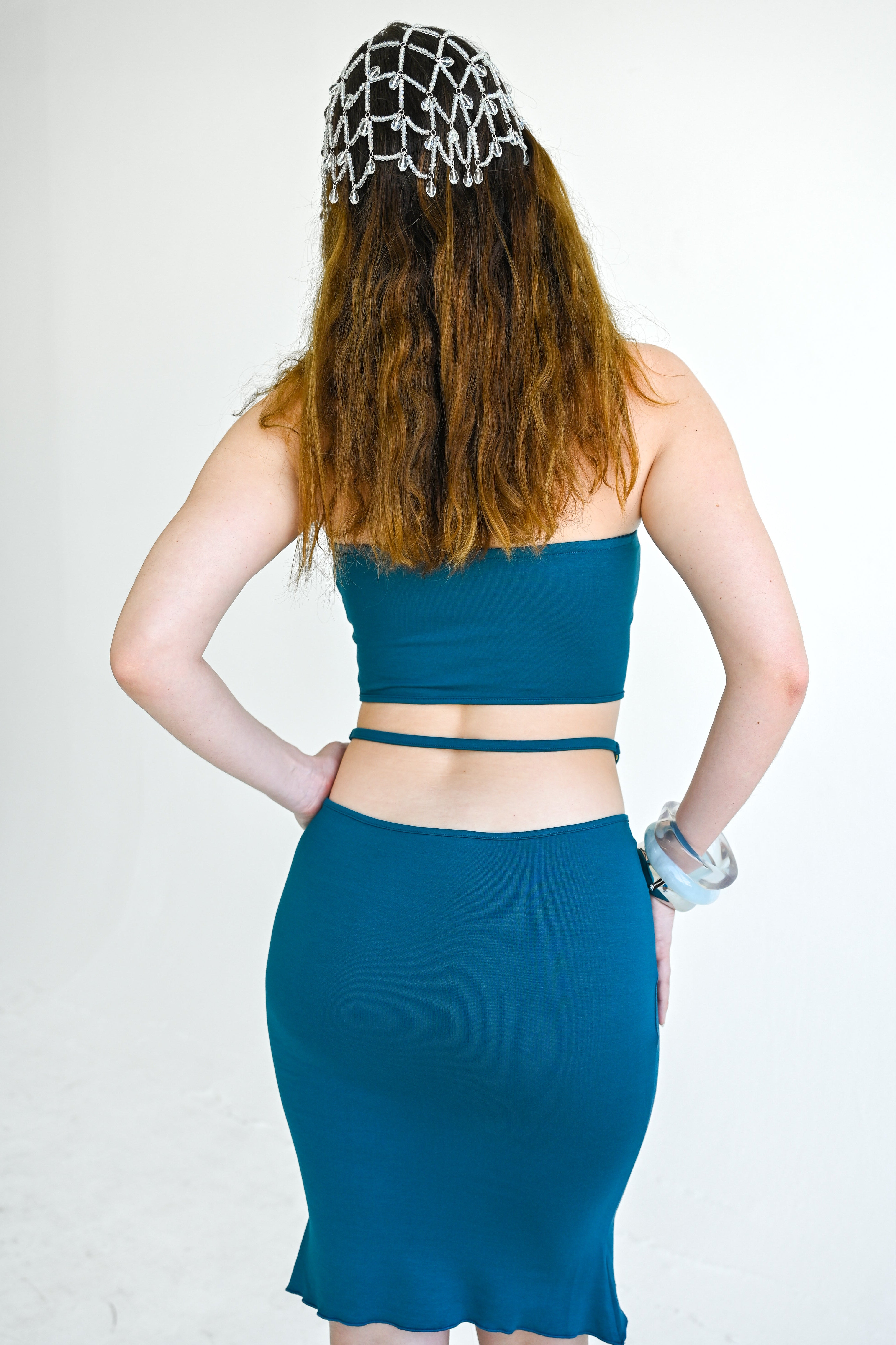 Person wearing a blue two-piece outfit with a white background